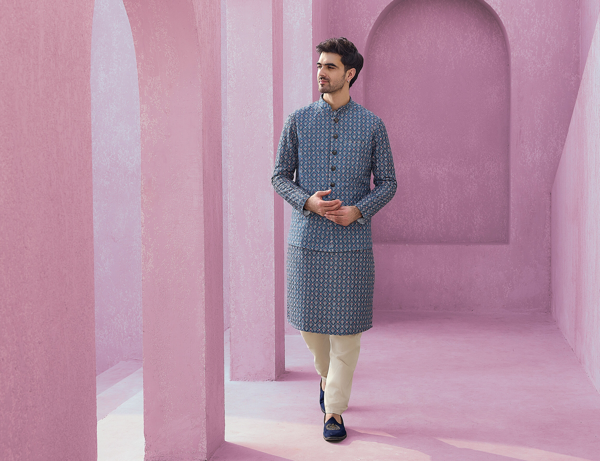 Man wearing a printed blue kurta jacket set and pajama